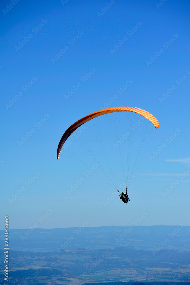 Paragliders in full flight over volcanoes of Puy de Dome Paragliders in full flight over volcanoes of Puy de Dome