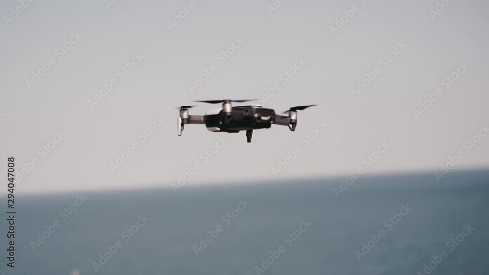 Man controling a drone.