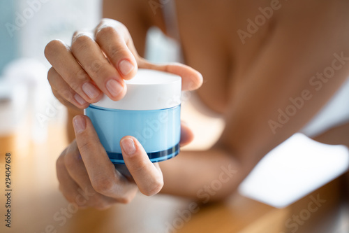 Woman hands holding a bottle of cream