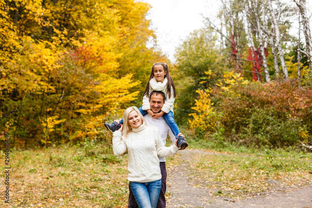 Fototapeta premium Family with child go in autumn park
