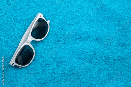 Sunglasses lie on a colored towel. Close-up.