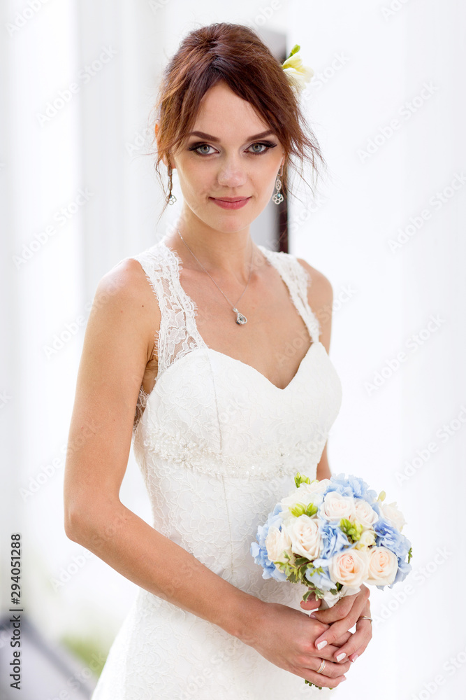 Portrait of bride with fascinating look in white dress. Portrait of bride with fascinating look in white dress.