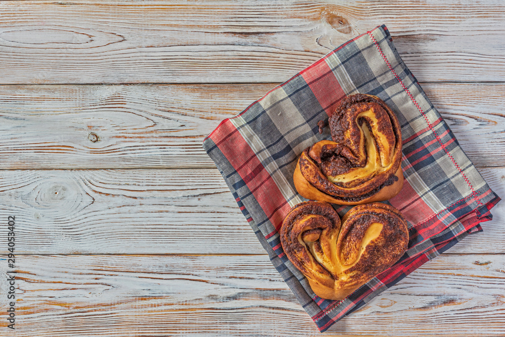 Cinnamon roll on a light wooden background. Cinnamon roll on a light wooden background.