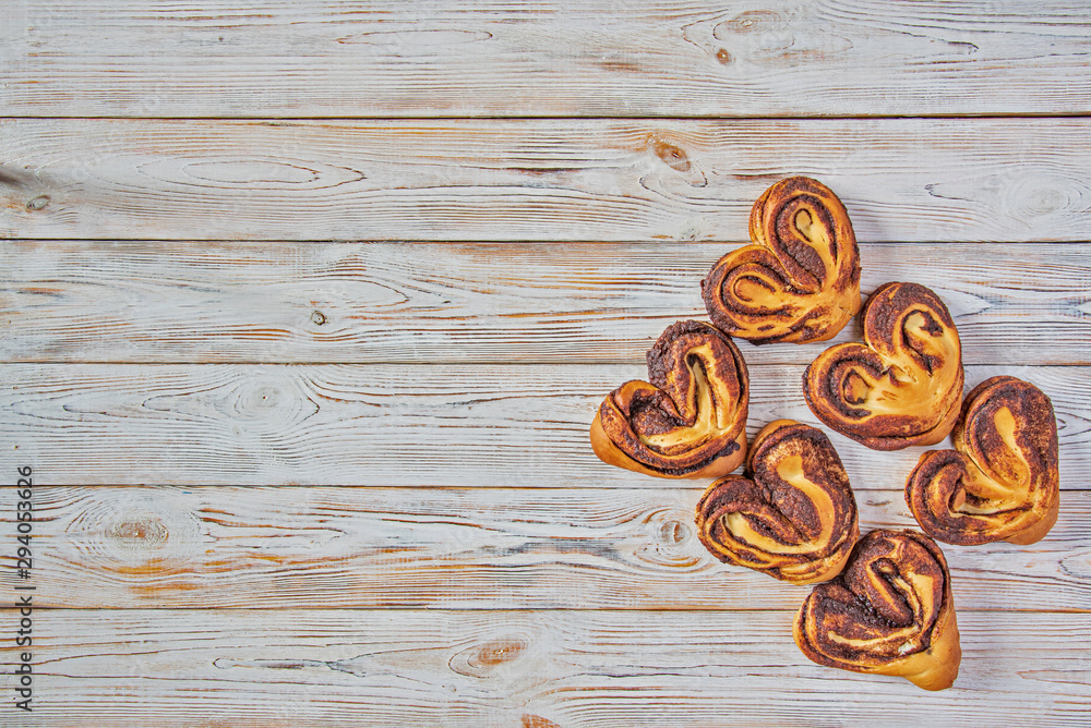 Cinnamon roll on a light wooden background. Cinnamon roll on a light wooden background.