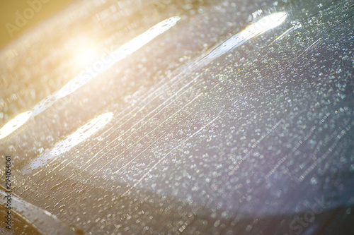 Closeup. Rain and drops on the modern car windshield.