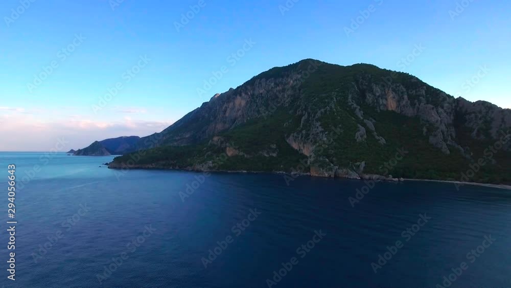 Aerial along the coast near Olympos Beach in Turkey. High drone forward dolly over the ocean Aerial along the coast near Olympos Beach in Turkey. High drone forward dolly over the ocean