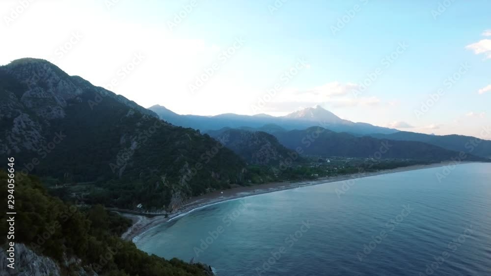 Aerial along the coast near Olympos Beach in Turkey. High drone forward dolly over the ocean Aerial along the coast near Olympos Beach in Turkey. High drone forward dolly over the ocean