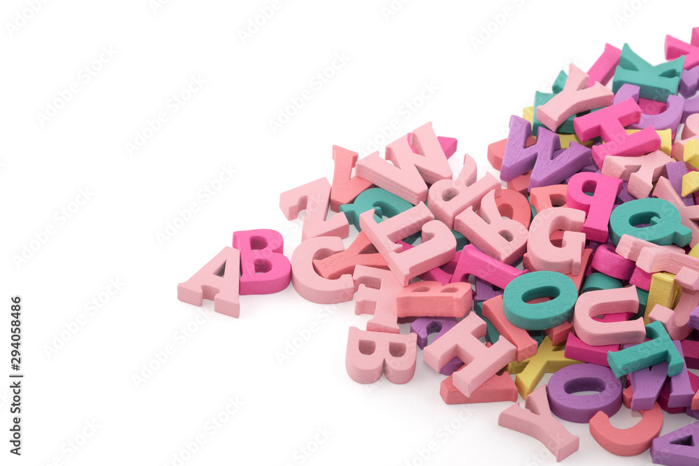 Naklejka premium Pile of colorful painted wooden letters. Typography background composition. 