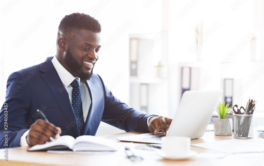 Cheerful young manager making market research online Cheerful young manager making market research online