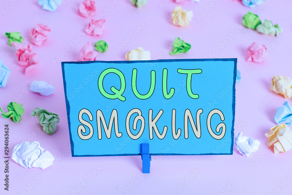 Writing note showing Quit Smoking. Business concept for process of discontinuing tobacco smoking or cessation Colored crumpled papers empty reminder pink floor background clothespin