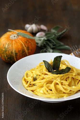 pasta spaghetti with pumpkin-cream sauce with sage and chips of sage leaves. autumn dish.