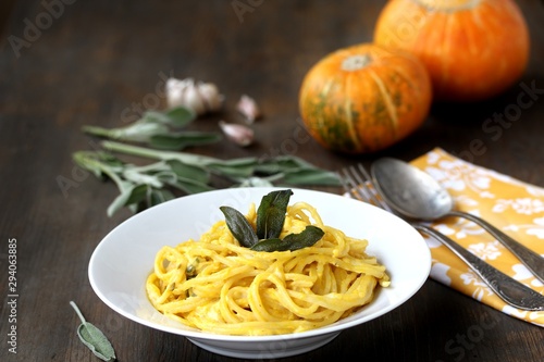 pasta spaghetti with pumpkin-cream sauce with sage and chips of sage leaves. autumn dish.