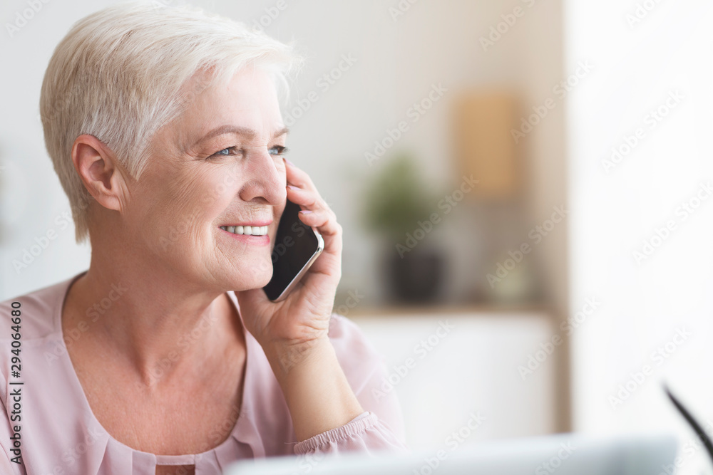 Close up of mature business woman talking by phone Close up of mature business woman talking by phone