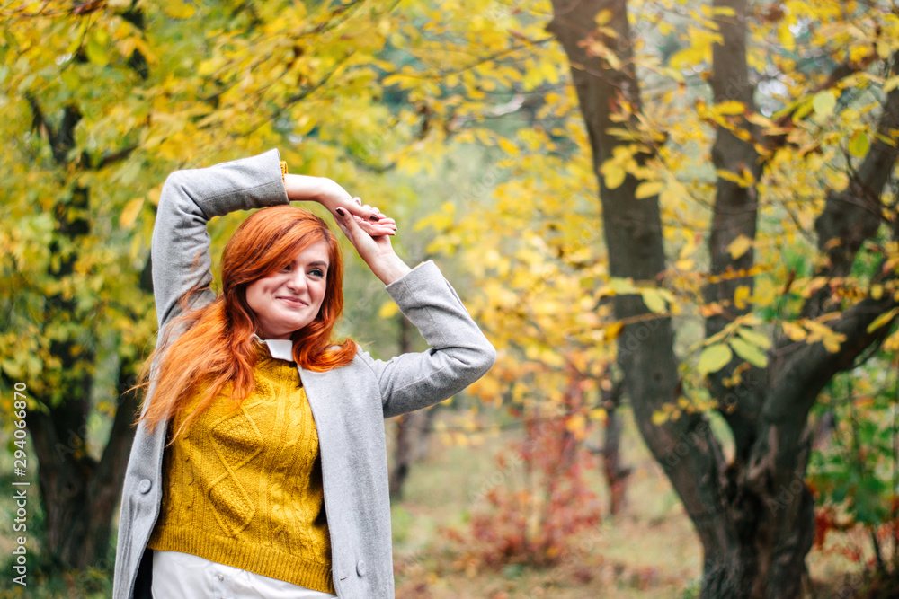 Portrait of a beautiful red-haired woman in autumn park Portrait of a beautiful red-haired woman in autumn park