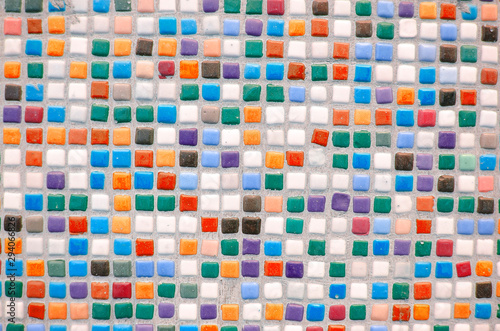 Bright multi-colored tile. Square color ceramic mosaic. Color optimistic background. Building decorative design concept. Place for text  lettering. Copy space. Selective focus image.