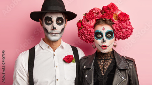 Fényképezés Surprised zombie man and spooky female wear mexican makeup, celebrate day of dea