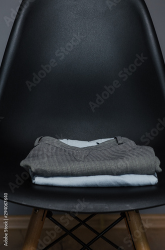 black chair with a stack of clothes photo