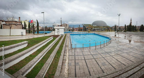 Bursa Panorama Conquest Museum. Modern museum, historical mosque, green grass stairs and pool on square. photo
