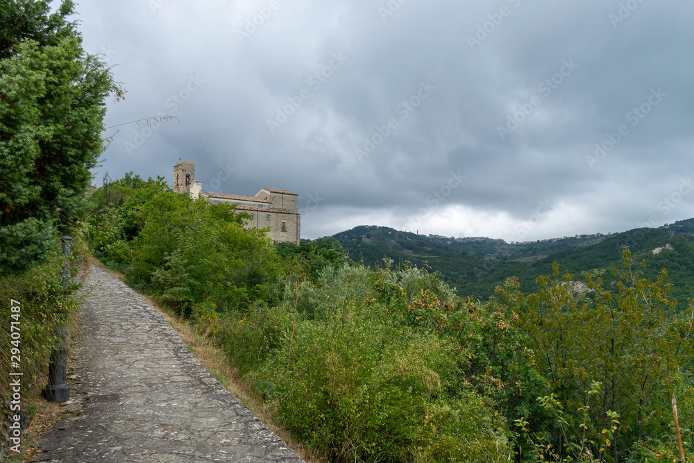 Stone road towards an ancient medieval church Stone road towards an ancient medieval church