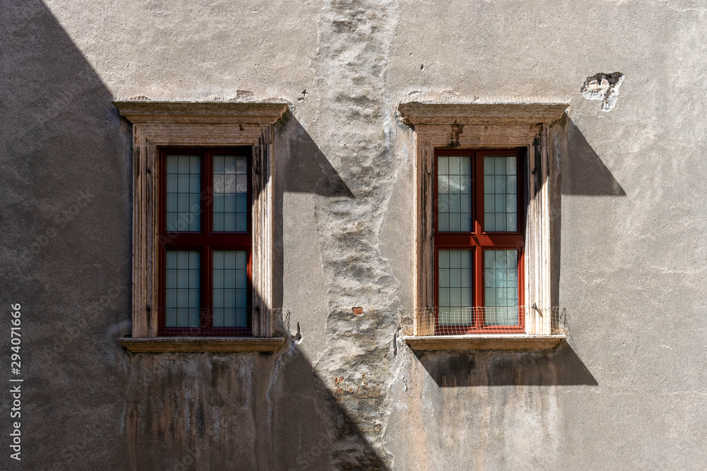 Pair of windows on a dark gray plastered wall