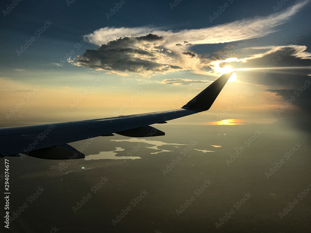 Sun setting over airplane wing Sun setting over airplane wing