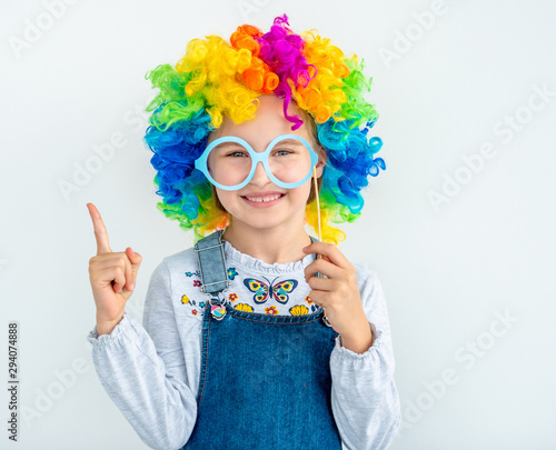 Happy little girl wearing clown wig