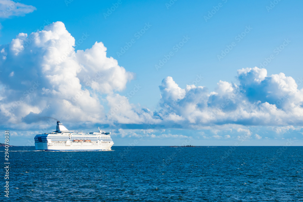 White cruise ship sailing on a blue sea. Sea voyage by ship. Sea cruise in Europe. Ferry in the Baltic sea. The ship left the port of Helsinki. Expanse.
