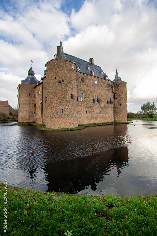 Fototapeta premium Medieval European Brick Castle with Large Moat and Later Renovations