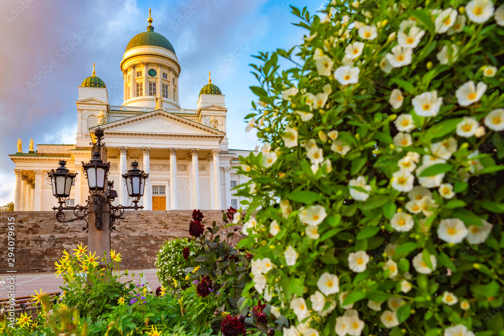 Helsinki. Finland. Suurkirkko. Cathedral Of St. Nicholas. Cathedrals Of Finland. Panorama of Senate square in the summer. Church on a background of flowers. Helsinki travel guide. Architecture
