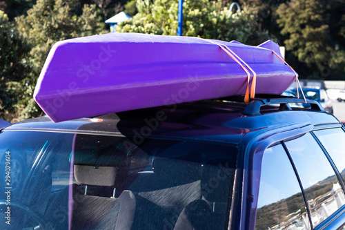 trip vacation tied kayak boat on top roof car in park