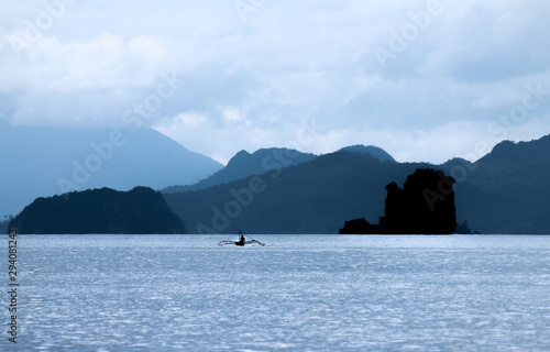 Serene shot of a Man in a Kayak with Philippine Islands in the Background