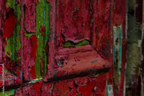 Flaking red painted door