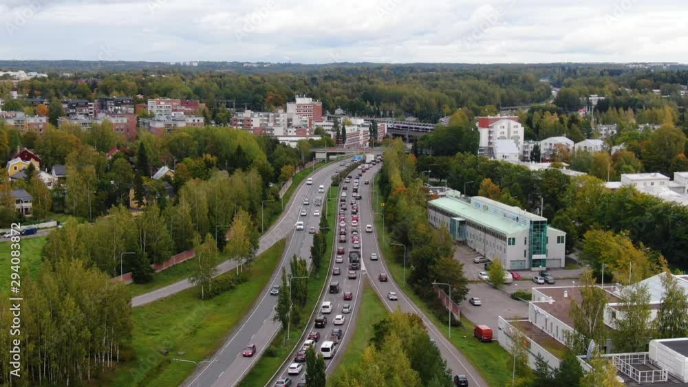 City traffic in a rush hour during the day. Cars driving slowly in a traffic jam on a busy road. City traffic in a rush hour during the day. Cars driving slowly in a traffic jam on a busy road.