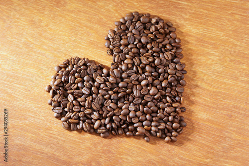 heart roasted coffee beans on wooden background