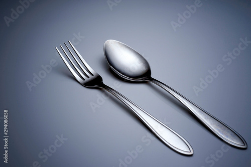 fork and spoon on dark background
