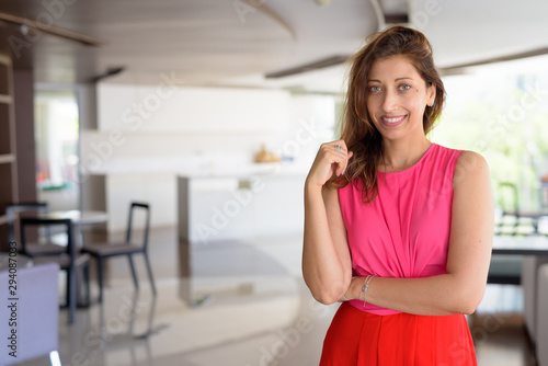 Free Download Happy beautiful Hispanic woman smiling at home indoors - GFXLoad