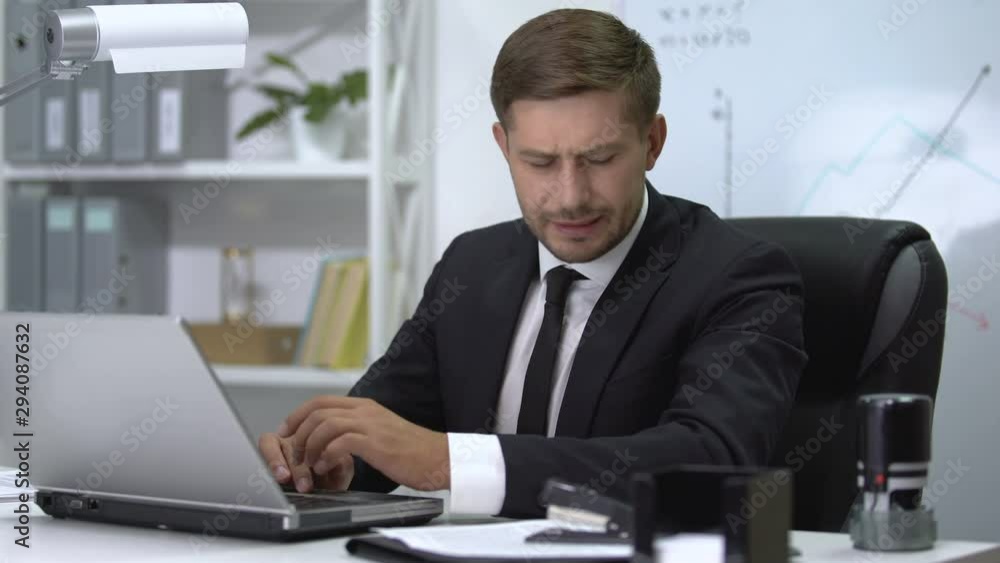 Young businessman suffering shoulder pain during typing on laptop, sprain result Young businessman suffering shoulder pain during typing on laptop, sprain result
