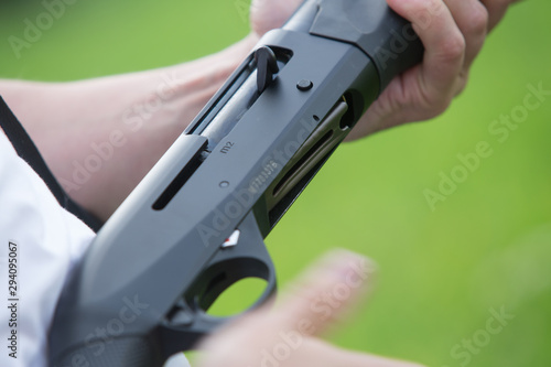Close up of a hunter loading his weapon