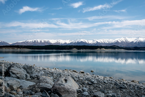 Stunning beauty of the snow covered Southern Alps surrounded by a gorgeous glacial lake