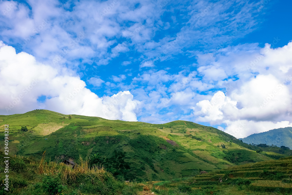 The beautiful landscape of Y Ty with mountains, clouds, blue sky, and rice fields, the most popular destination in Sapa, Vietnam. Royalty high-quality stock image of a landscape.