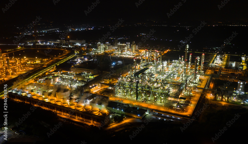 Aerial view night light oil terminal is industrial facility for storage of oil and petrochemical. oil manufacturing products ready for transport and business transportation. power electric plant. Aerial view night light oil terminal is industrial facility for storage of oil and petrochemical. oil manufacturing products ready for transport and business transportation. power electric plant.