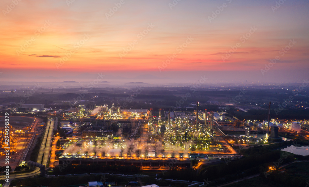 Aerial view night light oil terminal is industrial facility for storage of oil and petrochemical. oil manufacturing products ready for transport and business transportation. power electric plant.
