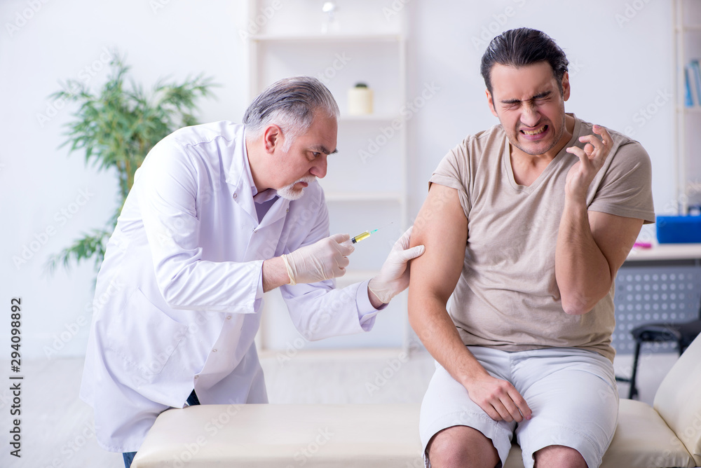 Fototapeta premium Male patient visitng doctor for shot inoculation