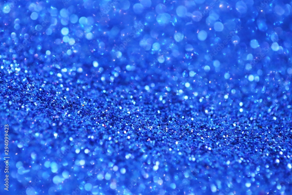 blue glitter with bokeh background.Christmas festive winter background.Shiny texture with highlights. Blue bokeh surface. sparkling shiny paper.Christmas holiday seasonal wallpaper blue glitter with bokeh background.Christmas festive winter background.Shiny texture with highlights. Blue bokeh surface. sparkling shiny paper.Christmas holiday seasonal wallpaper