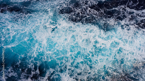 Texture of marine splashes. crashing ocean wave foam structure. Dark blue clear water. Ocean depth.