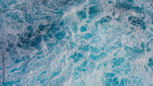 Texture of marine splashes. crashing ocean wave foam structure. Dark blue clear water. Ocean depth. © Artem