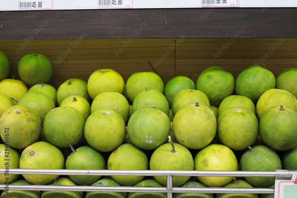 Big green oranges on a shelter in super market