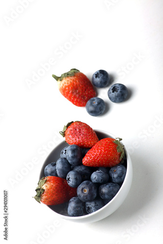 a bowl of strawberry and blueberry isolated on white background