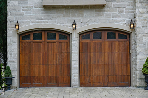 Tableau sur toile Twin wooden garage doors of stone house