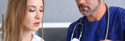 Obraz na płótnie Smiling handsome doctor communicate with patient holding silver pen and showing pad. Physical agreement signature disease prevention consent sign 911 prescribe remedy healthy lifestyle concept w salonie